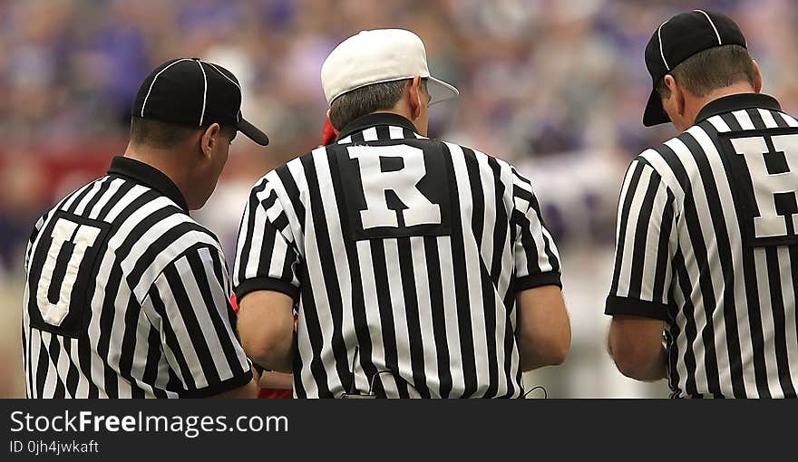 3 Referees Standing on Field