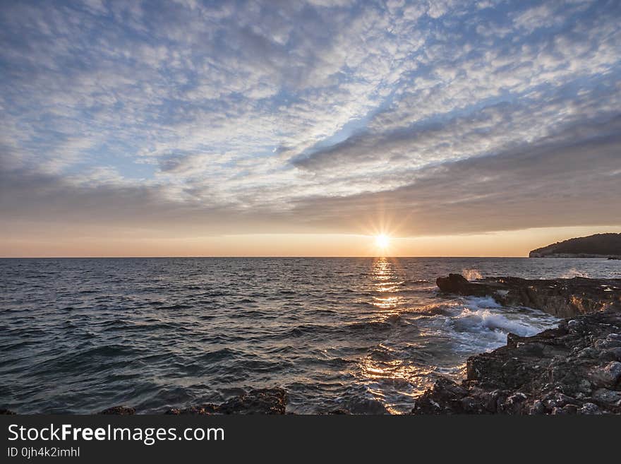 Black Rock Beside the Sea Under the Sunset