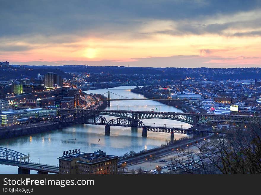 Panorama View of Suspension Bridge Connecting Urban City during Golden Hour