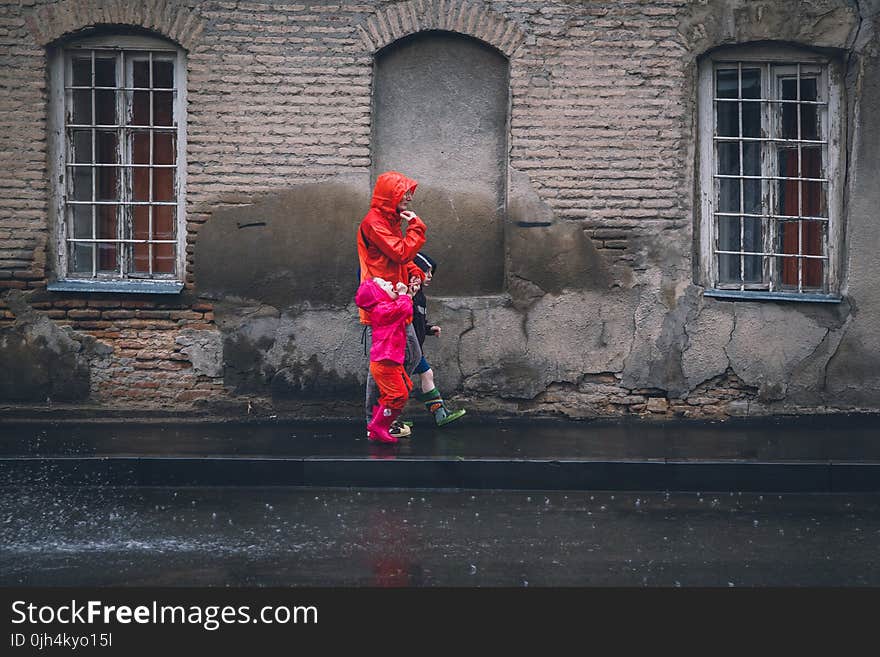 Children and Man Walking on a Sidewalk during Daytime