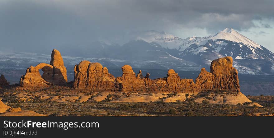 Valley Near Snowy Mountain during Daytime