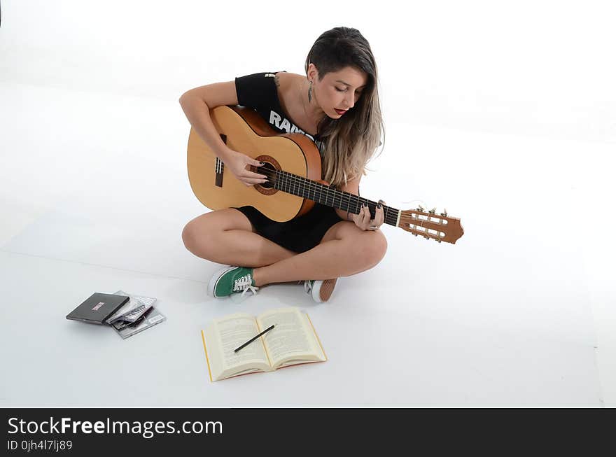 Woman Playing Brown Classical Guitar