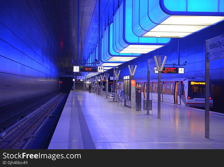 White Ceramic Tiles Near Black Train Rail