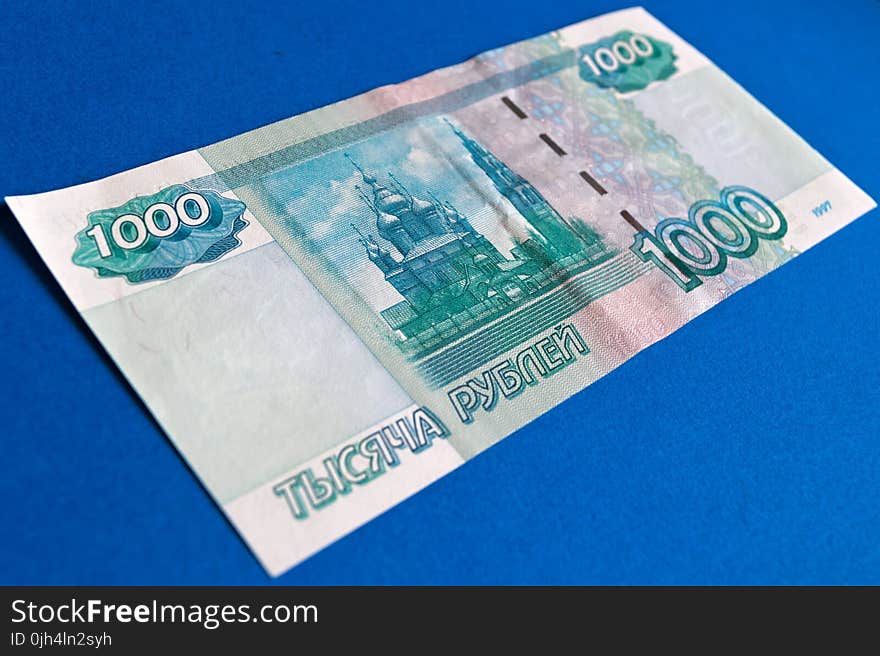 1000 Banknote on Top of Blue Surface