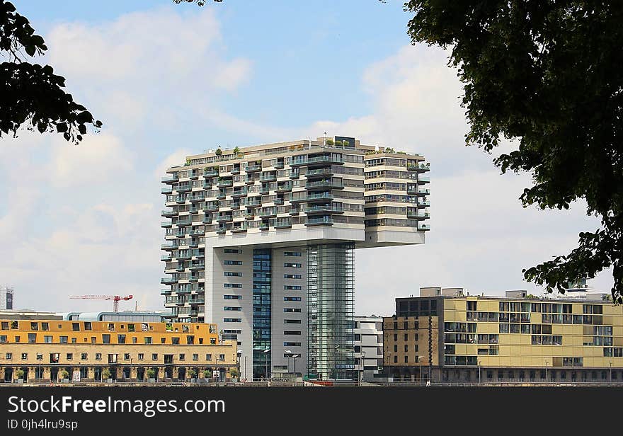 White and Gray Concrete Building Under Cloudy Blue Sky during Daytime