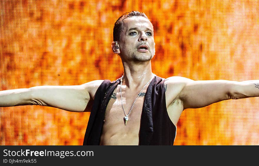 Man in Black Vest Lifting His Hands