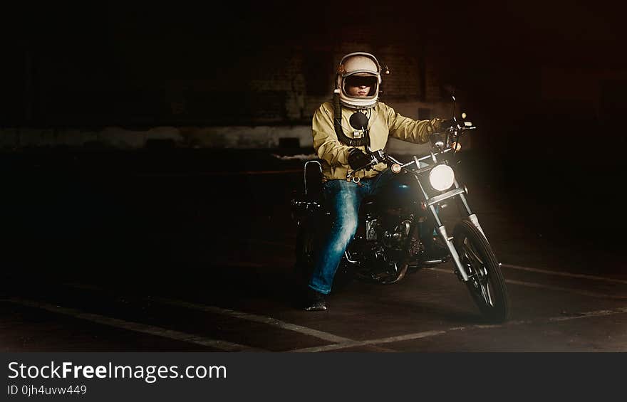 Man Wearing White Full Face Helmet Riding on Standard Motorcycle