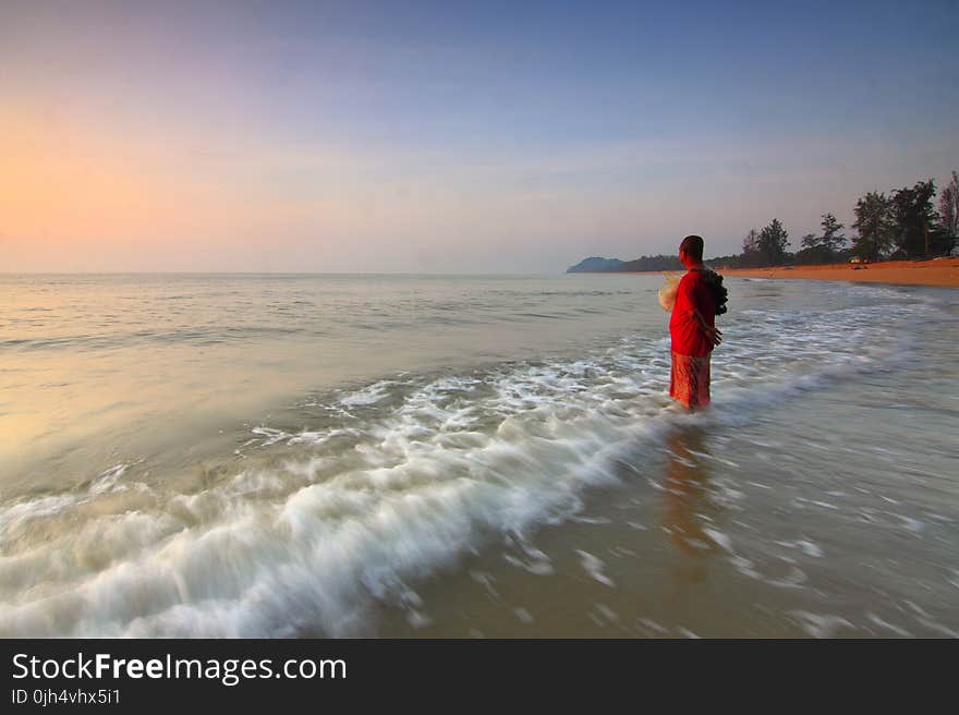 Person on the Seashore during Sun Set