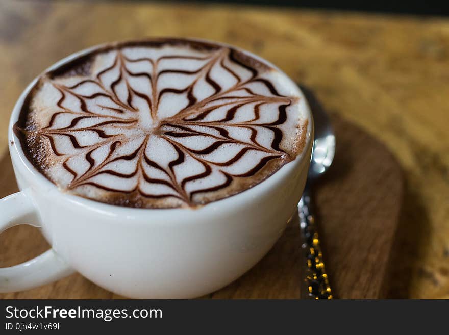 Black and Beige Coffee on White Ceramic Teacup