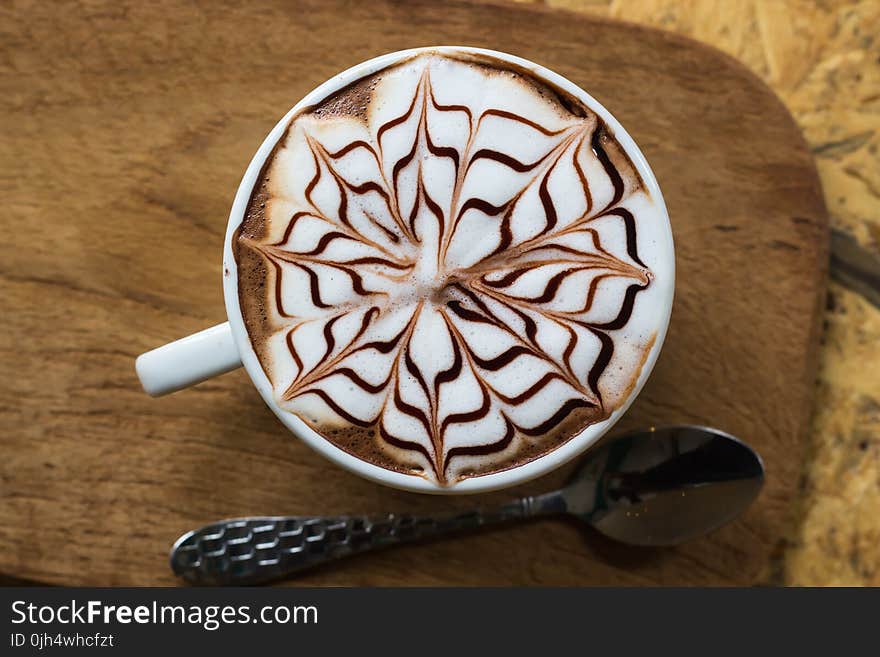 Brown and White Coffee With Floral Art in White Ceramic Mug