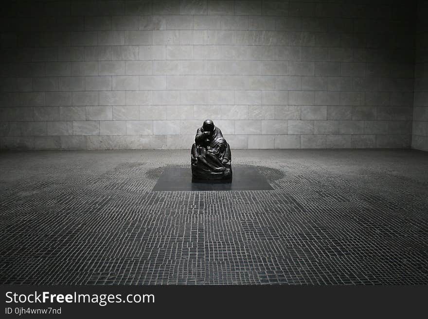 Man in Monk Suit Sitting