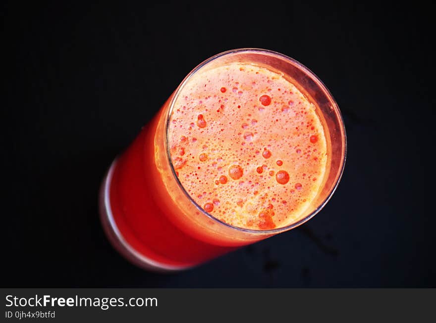 Glass of Orange Liquid in Close Up Photography