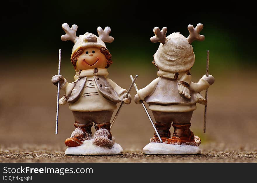 Beige and Brown Boy Skiing Figurine