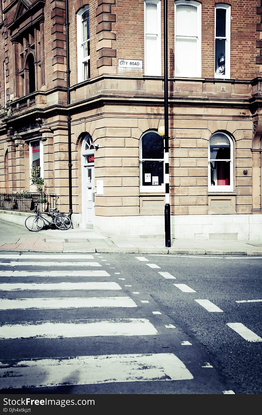 Black Bicycle Parked on the Edge of a Street during Daytime