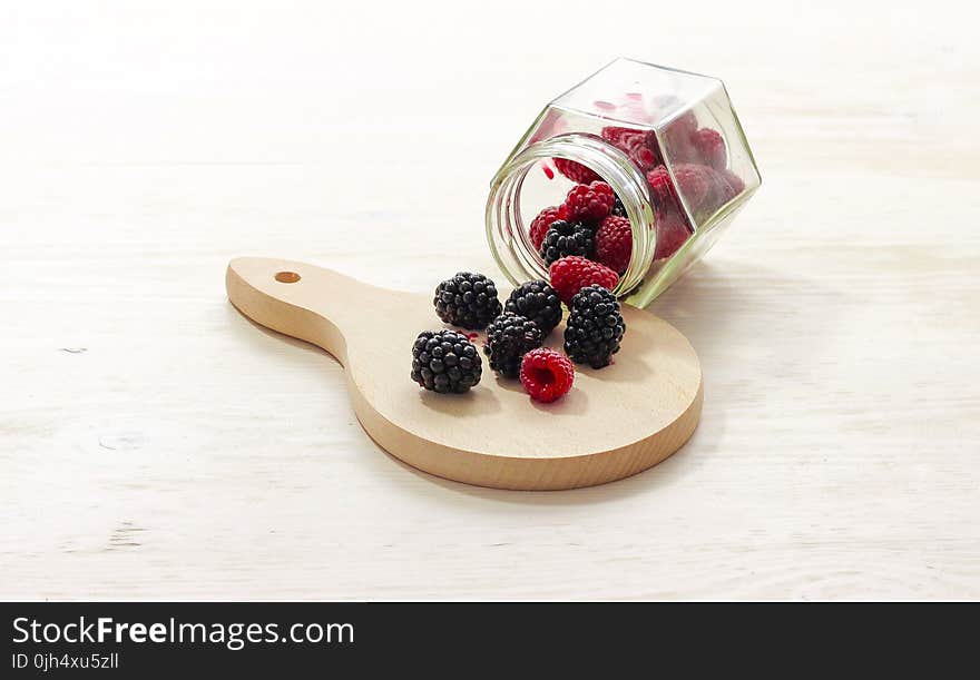 Clear Glass Bottle With Raspberries Inside