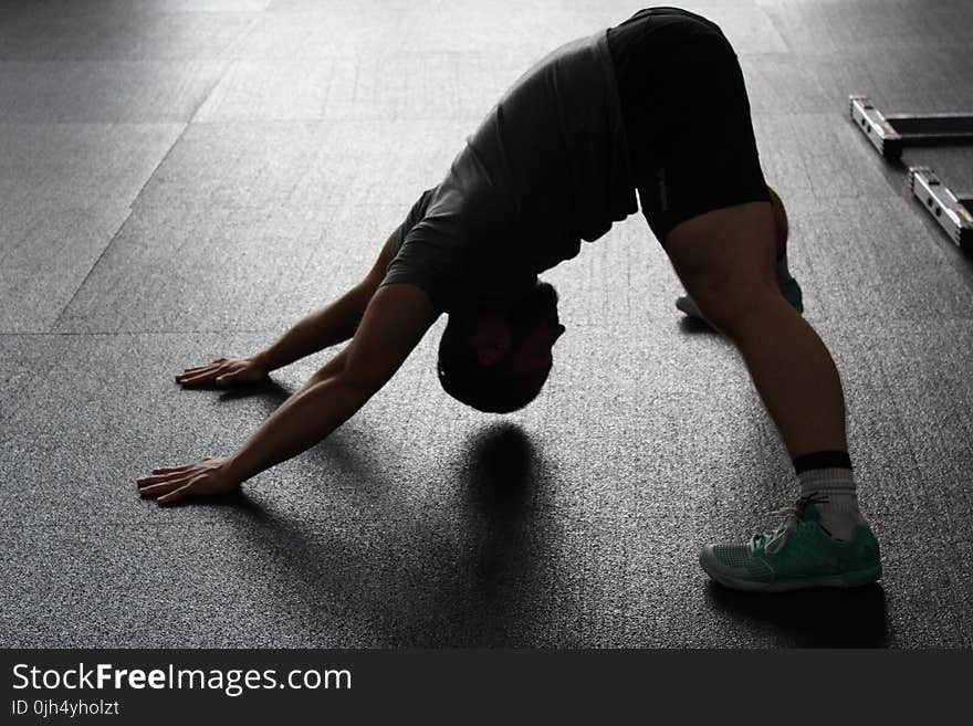 Man in Grey Shirt Doing Yoga on Gray Ceramic Tile Floor