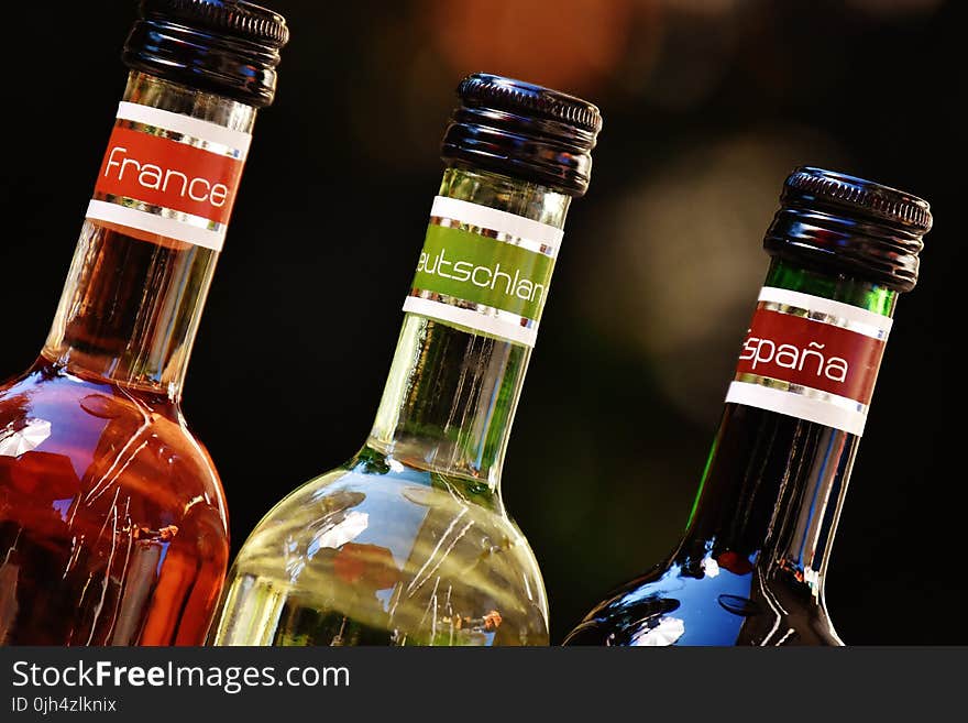 Shallow Focus Photofrapy of France Leutschien Espana Labeled Glass Bottles