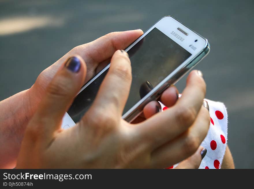 Human Hand Holding White Samsung Duos Android Smartphone