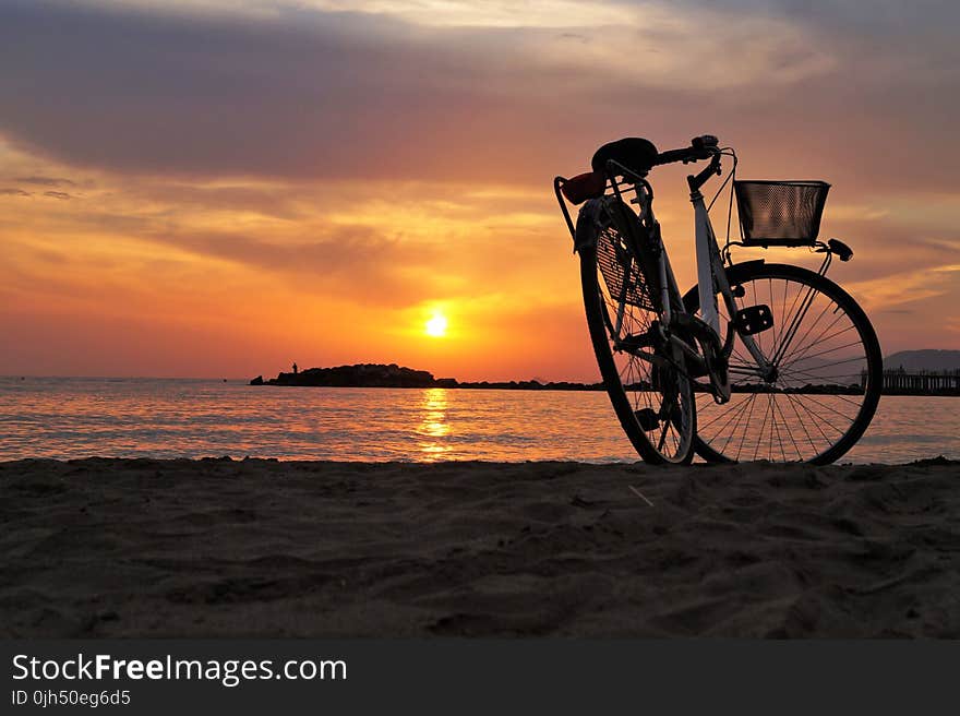 White Hard Tail Bicycle on Brown Beach Sand during Sunsets