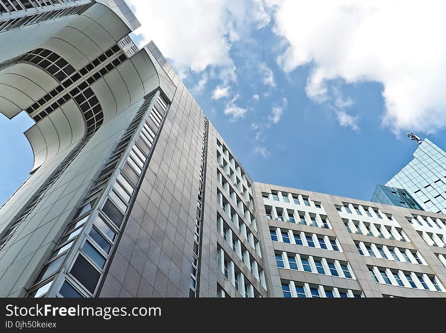 Grey Concrete High Rise Building Under Blue Sky