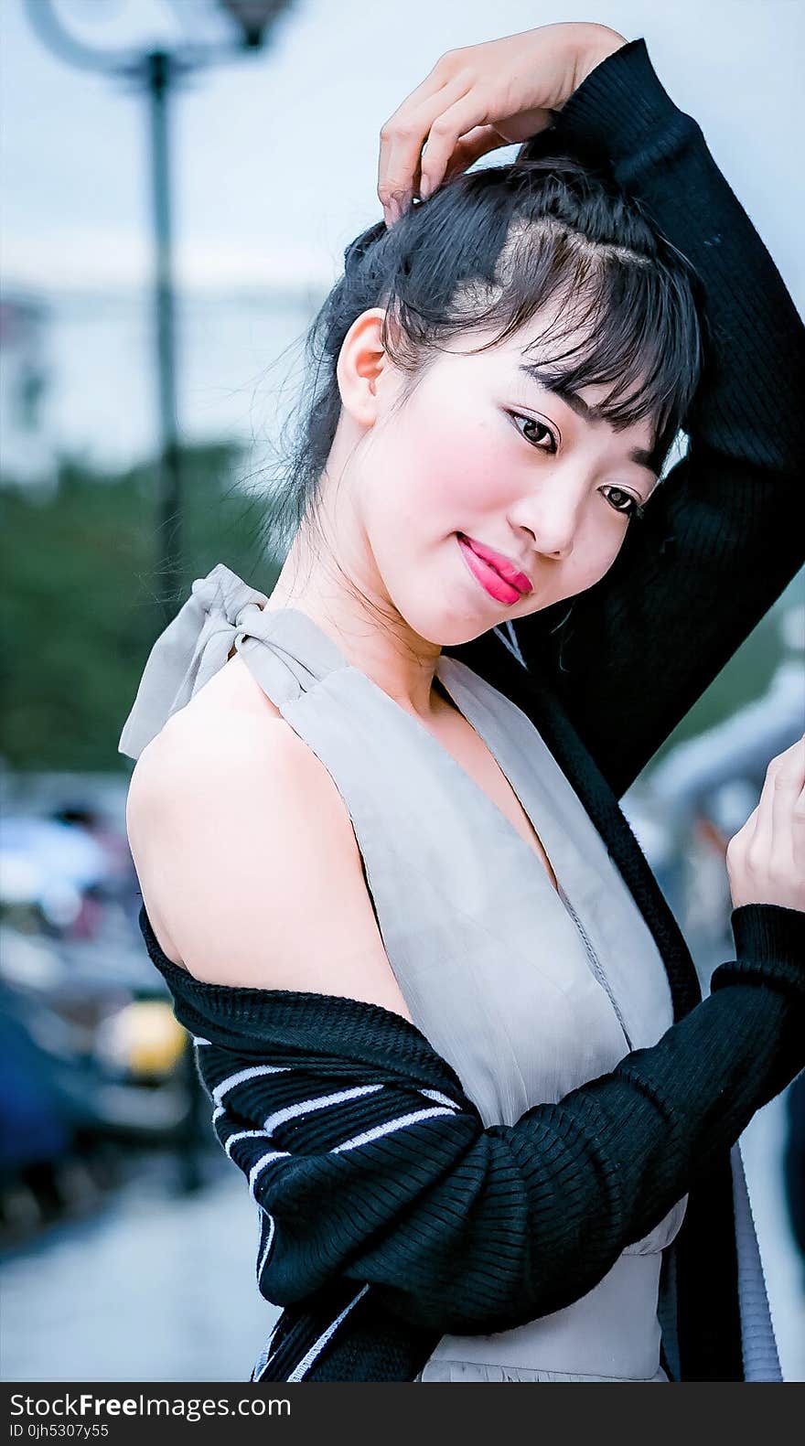 Woman in Gray Halter Dress Standing on Street