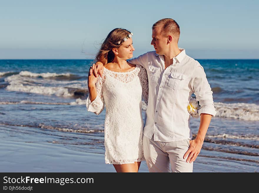 Couple Looking at Each Other Beside Beach