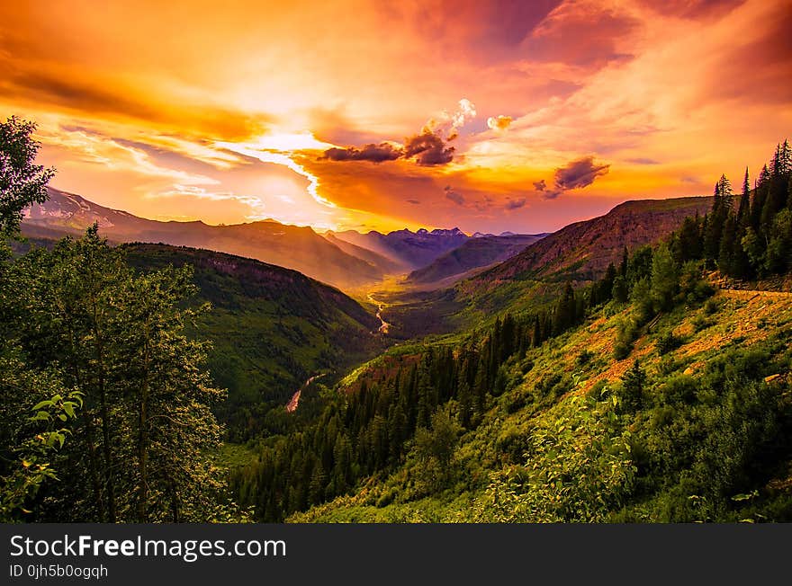 Green Mountain Near River Under Cloudy Sky during Daytime