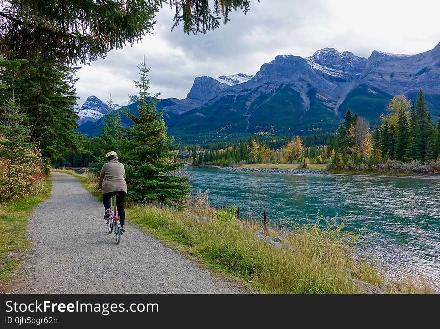 Rear View of Woman Walking on Mountain Road