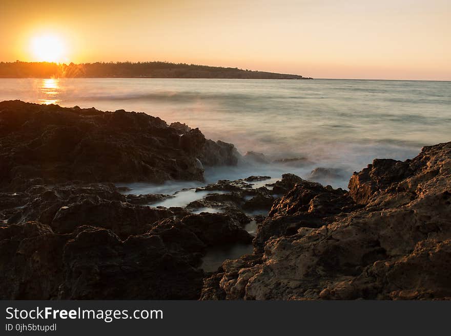 Scenic View of Sea Against Dramatic Sky during Sunset