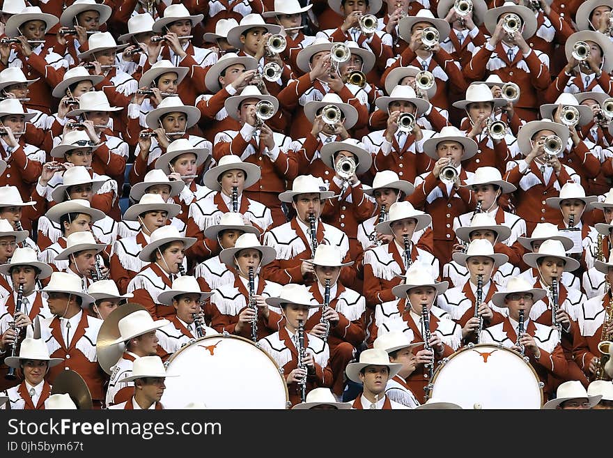 Group of People in White Hat Playing Together Different Kinds of Musical Instruments