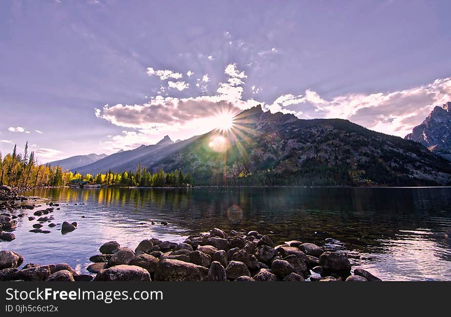 Scenic View of Lake by Mountains Against Sky at Night