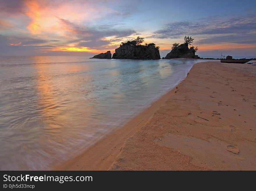 View of Beach Against Cloudy Sky