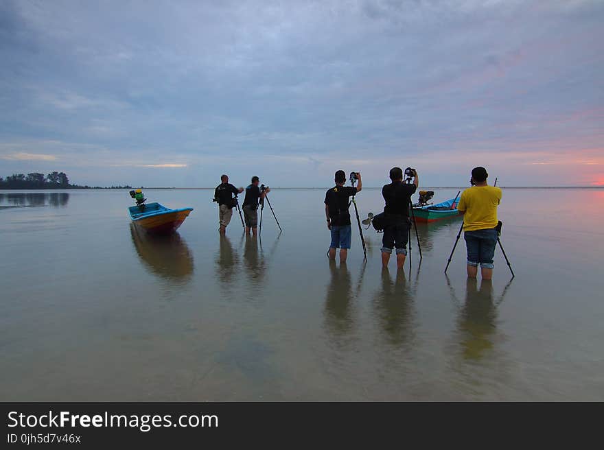 People on Beach Against Sky