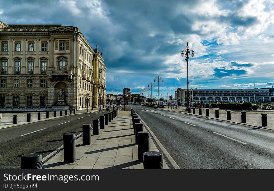 View of City Street Against Cloudy Sky