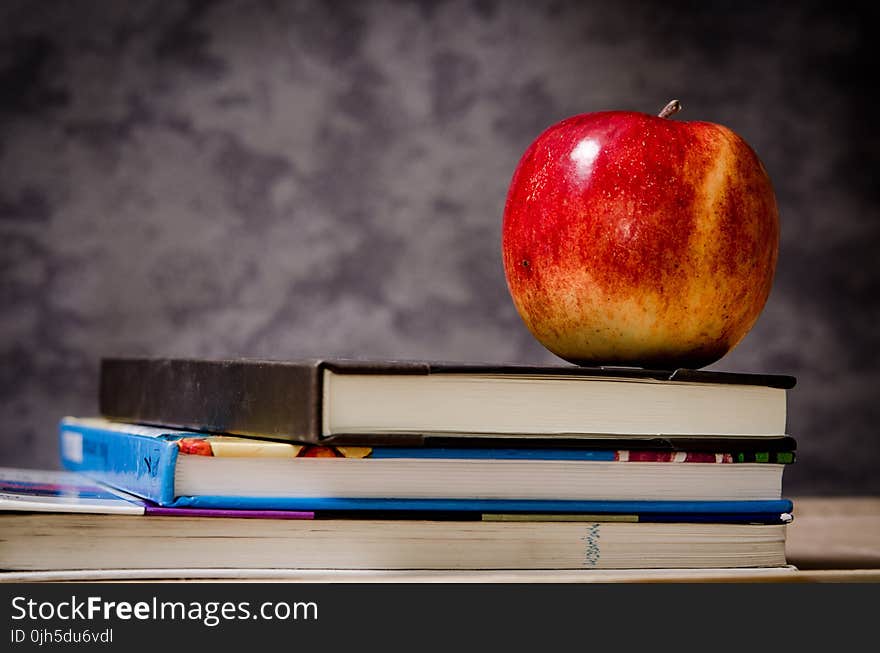 Close-up of Apple on Top of Books