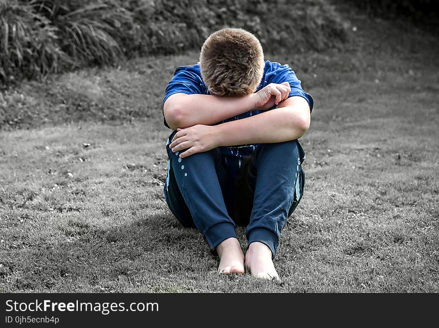 Rear View of a boy Sitting on Grassland