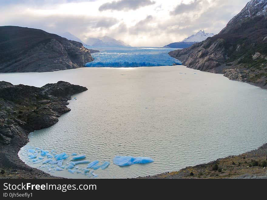 Scenic View of Sea and Mountains Against Sky