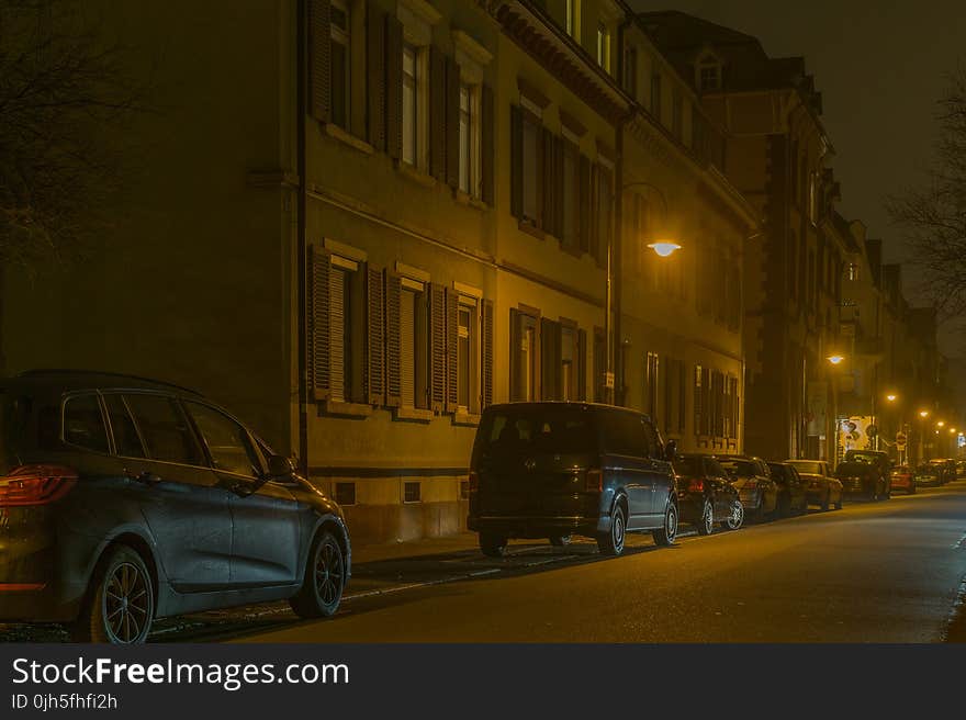 Cars in Illuminated City at Night