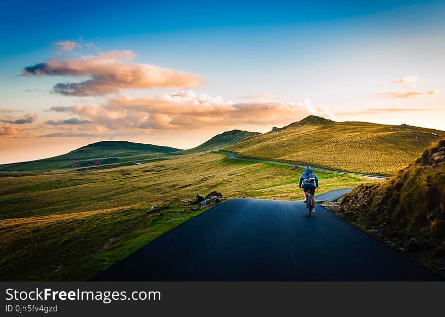 Rear View of Man on Mountain Road Against Sky