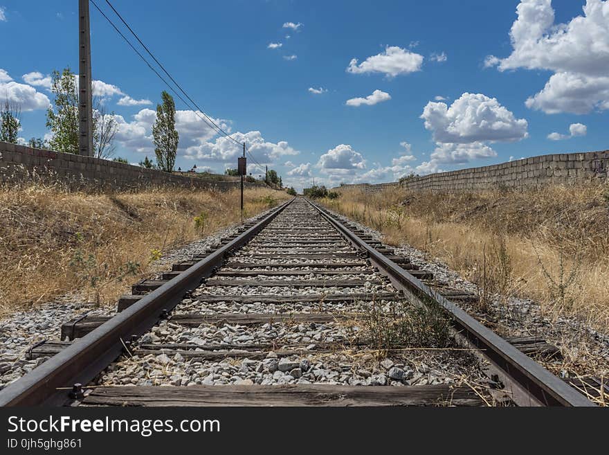 Railroad Track Amidst Trees Against Sky