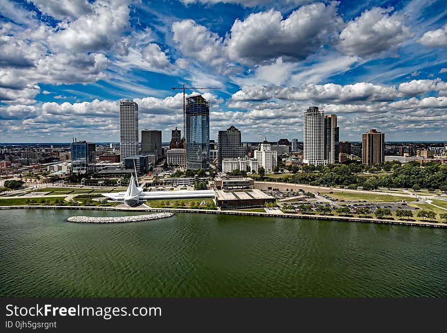 City at Waterfront Against Cloudy Sky