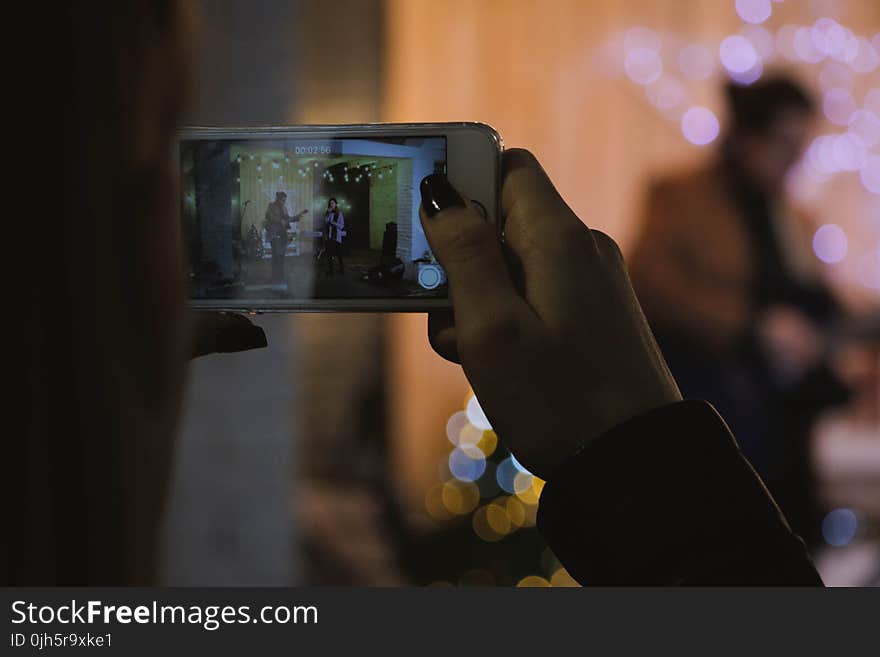 Shallow Focus Photography of Person Holding Silver Iphone 6s