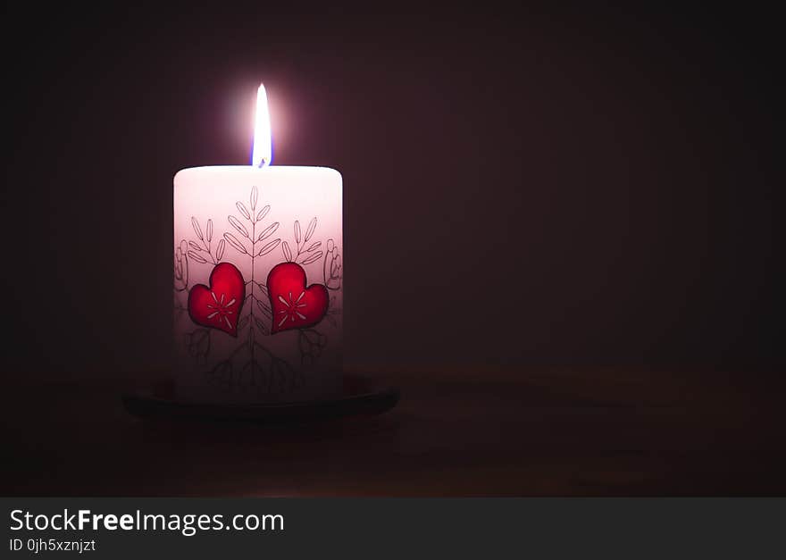 Close-up of Illuminated Candle Against Black Background