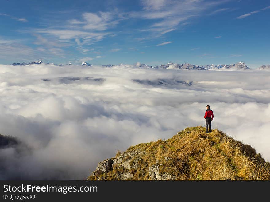 Man Standing on Mountain Against Sky