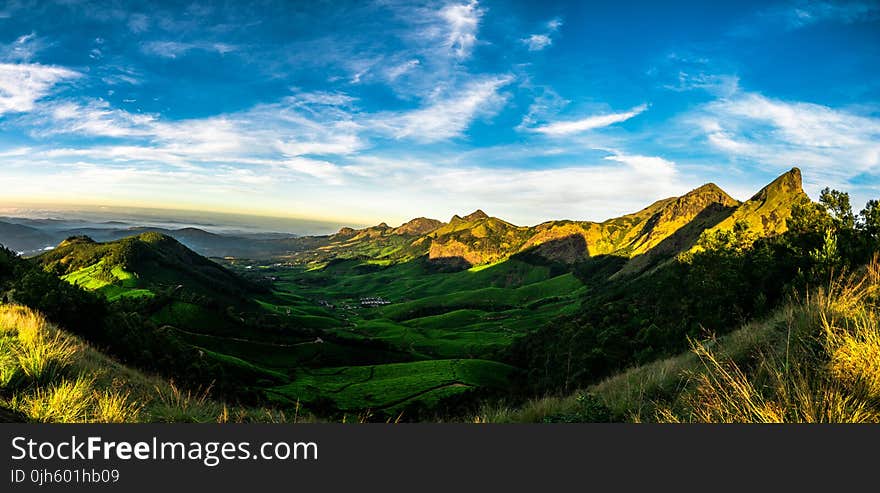 Scenic View of Mountains Against Cloudy Sky