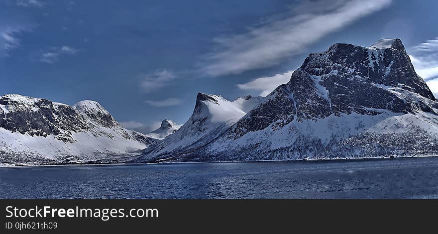 Scenic View of Lake Against Mountain Range