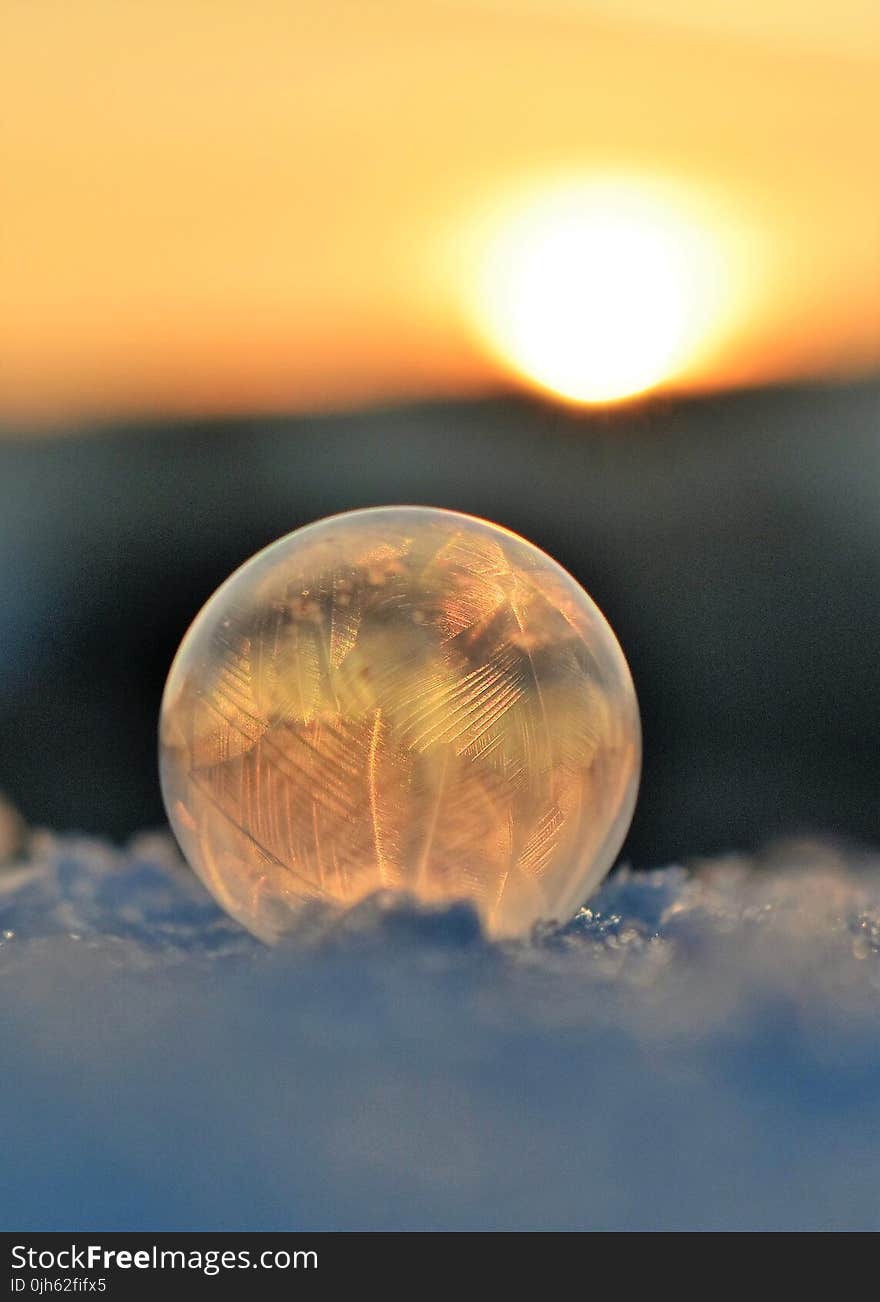 Frozen Soap Bubble Against Sky during Sunset