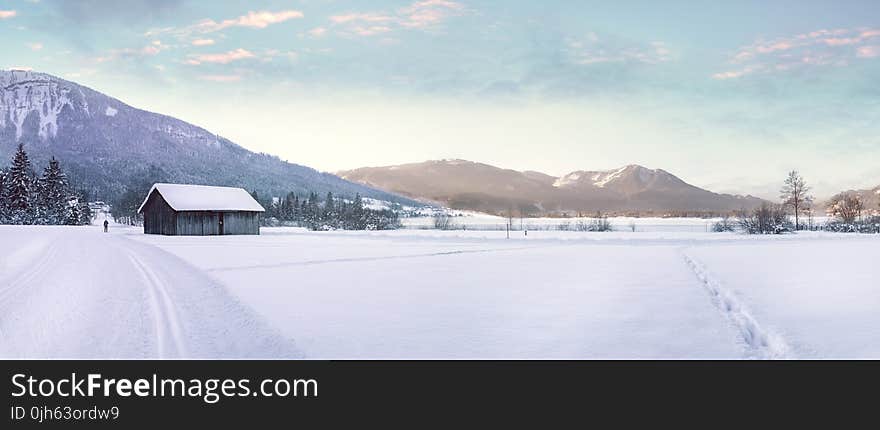 Snow Covered Landscape Against Mountain Range