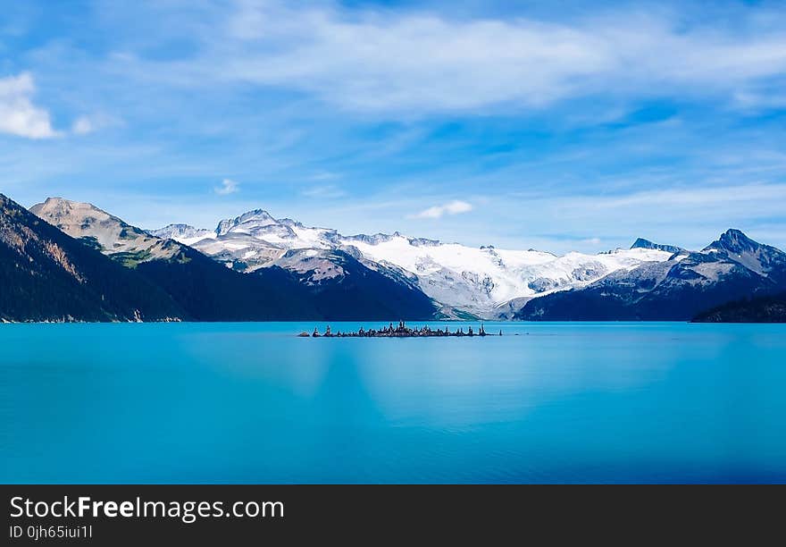 Scenic View of Frozen Lake Against Mountain Range