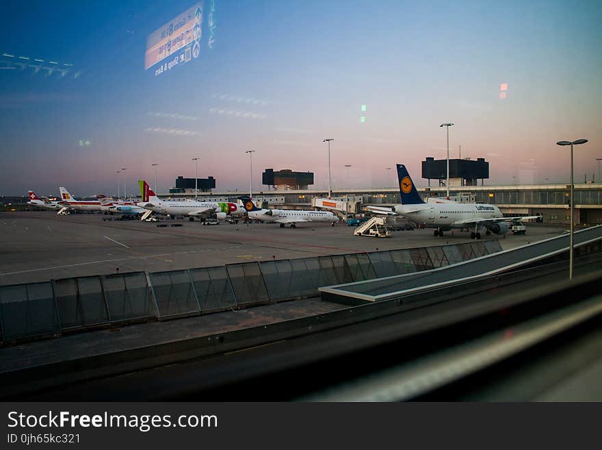 Airplanes on Hangar Under Blue Sky